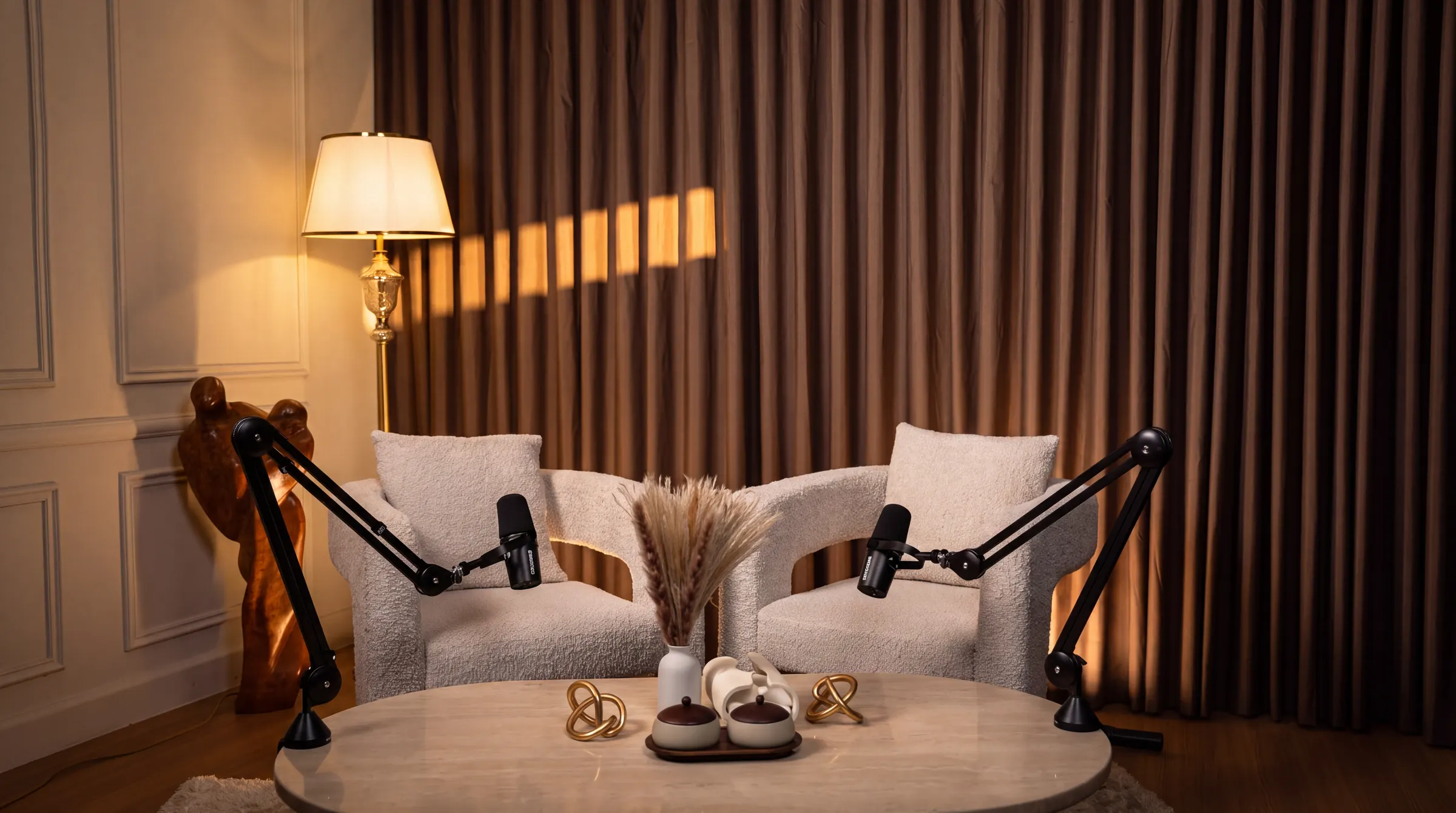 Cream podcast set with two bouclé armchairs and Shure boom microphones — Podflix Studio, Business Bay Dubai