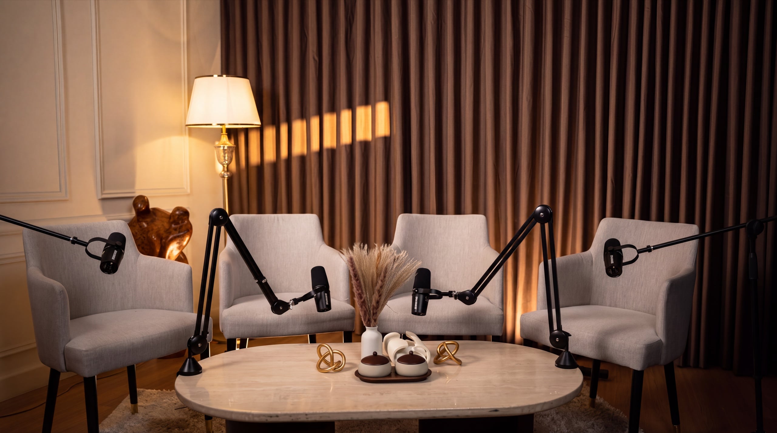 Four-person panel podcast set with four lounge armchairs — Podflix Studio Dubai